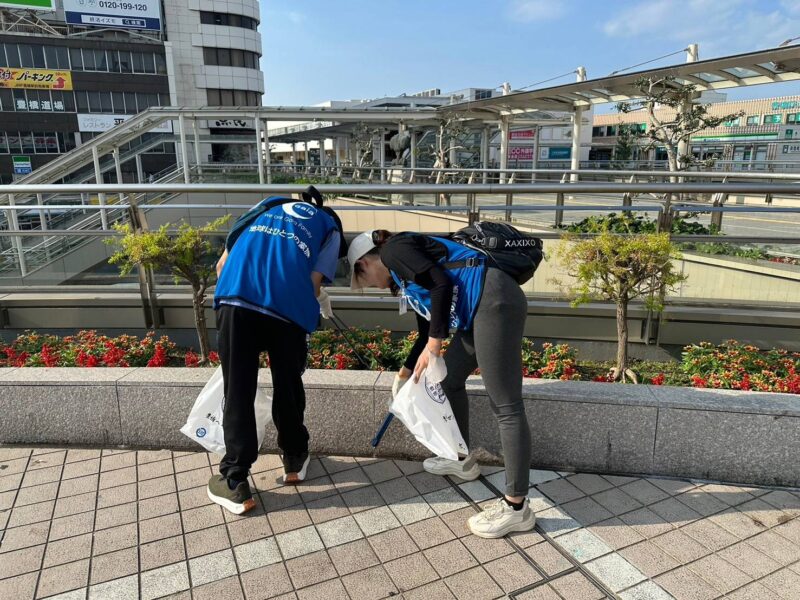 2人の女性が駅の構内でゴミを拾っている